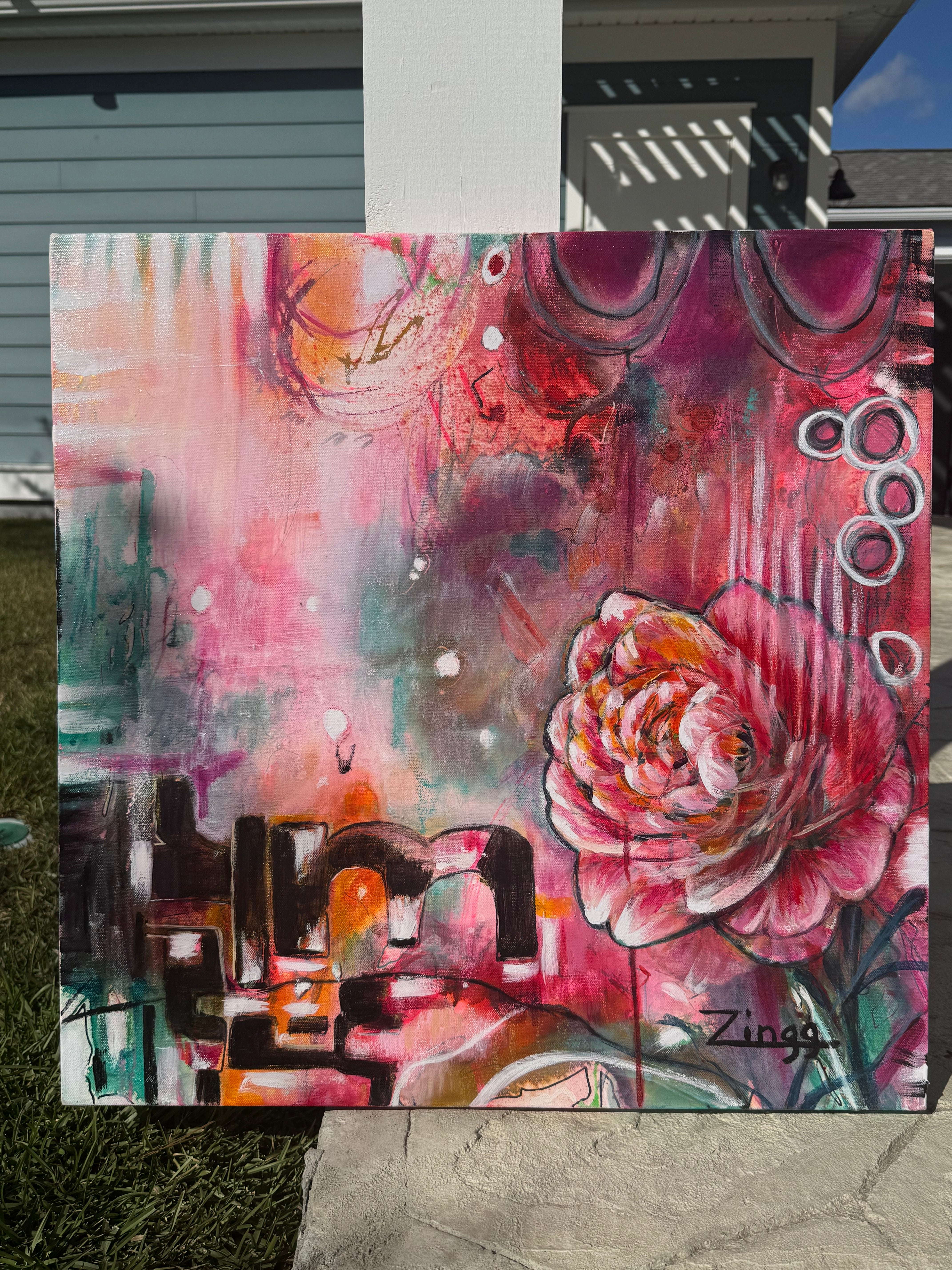 Abstract artwork with floral elements and geometric shapes on a textured surface.